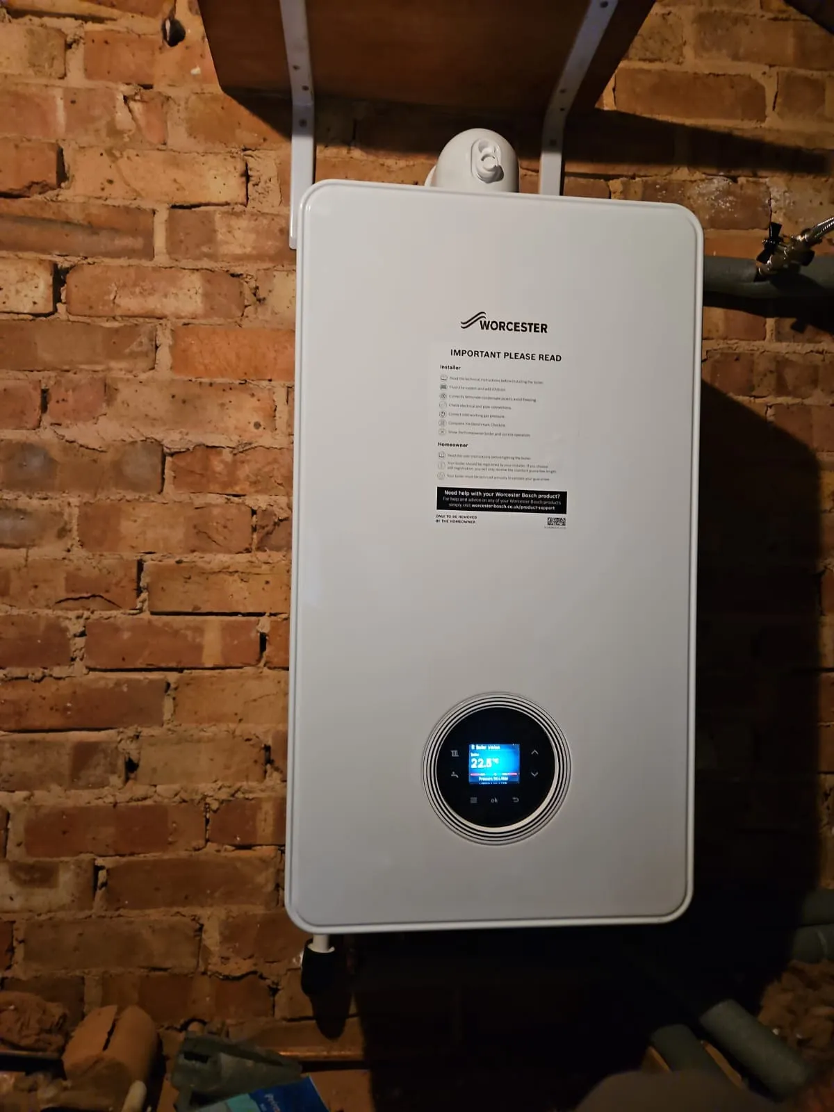 An image of a newly installed white radiator and associated copper piping, part of a recent boiler installation in Slough.