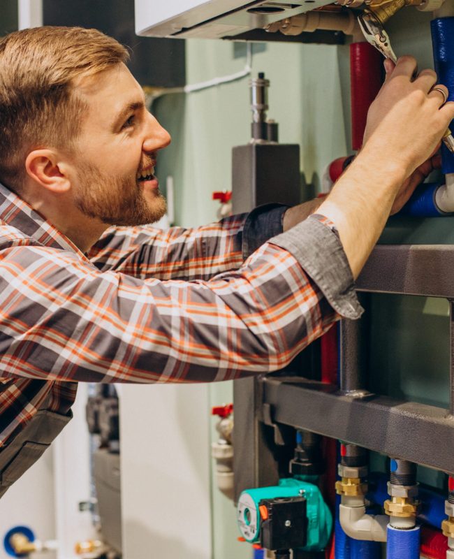 Young engineer adjusting autonomous heating Young engineer adjusting autonomous heating